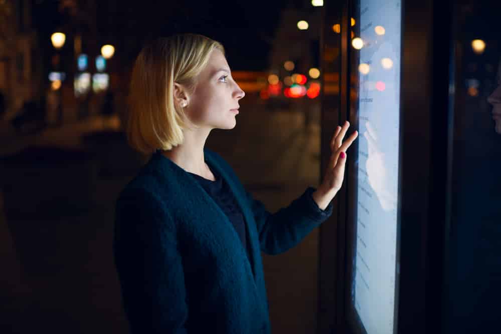 Woman using touch screen to research if you have to pay import tax from china